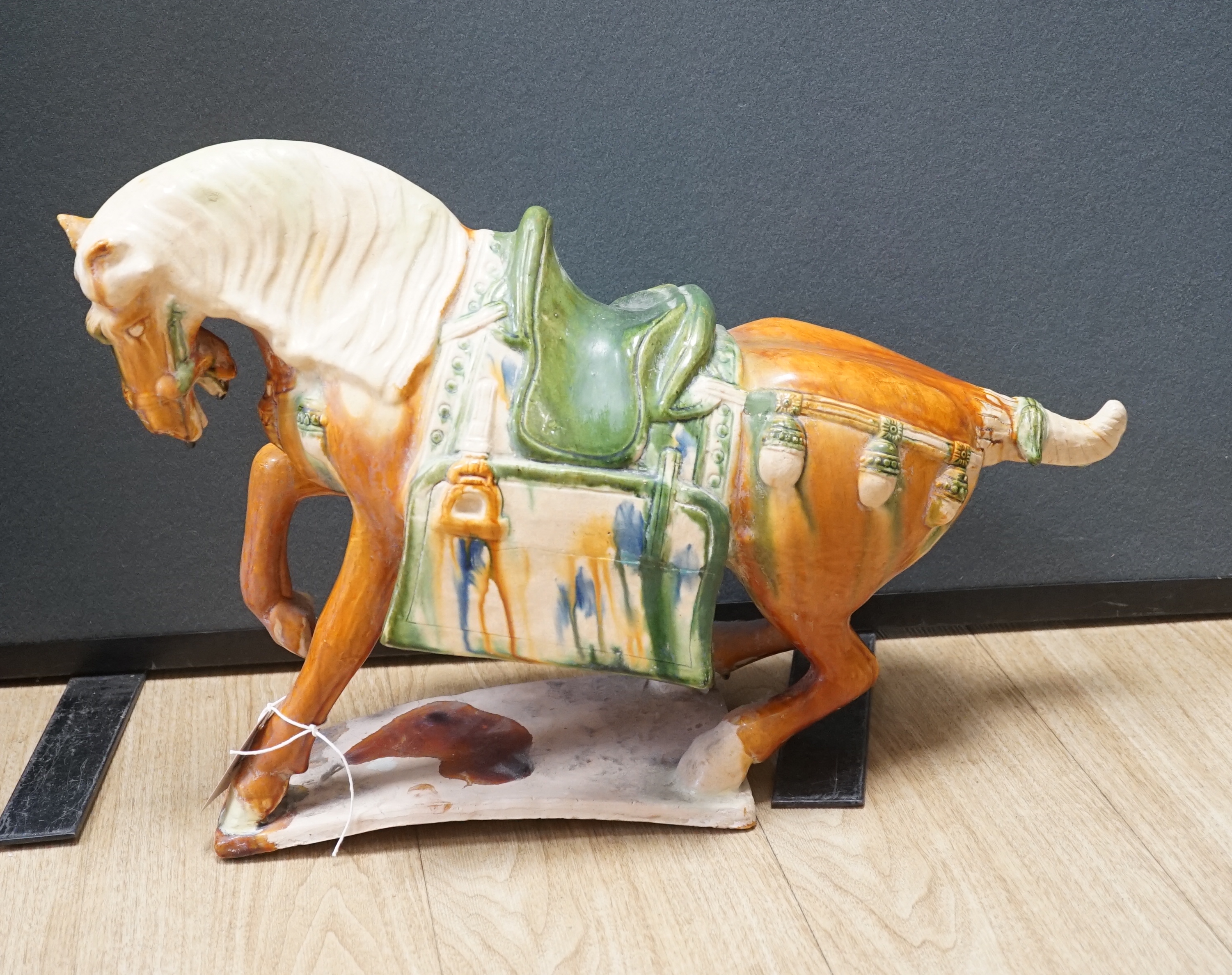 A large Chinese Tang-style pottery model of a tomb horse, 54cm long